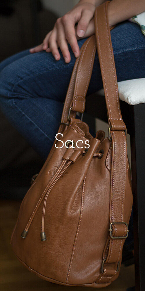 Sacs – voir la collection. Sac seau convertible en cuir marron porté à la main